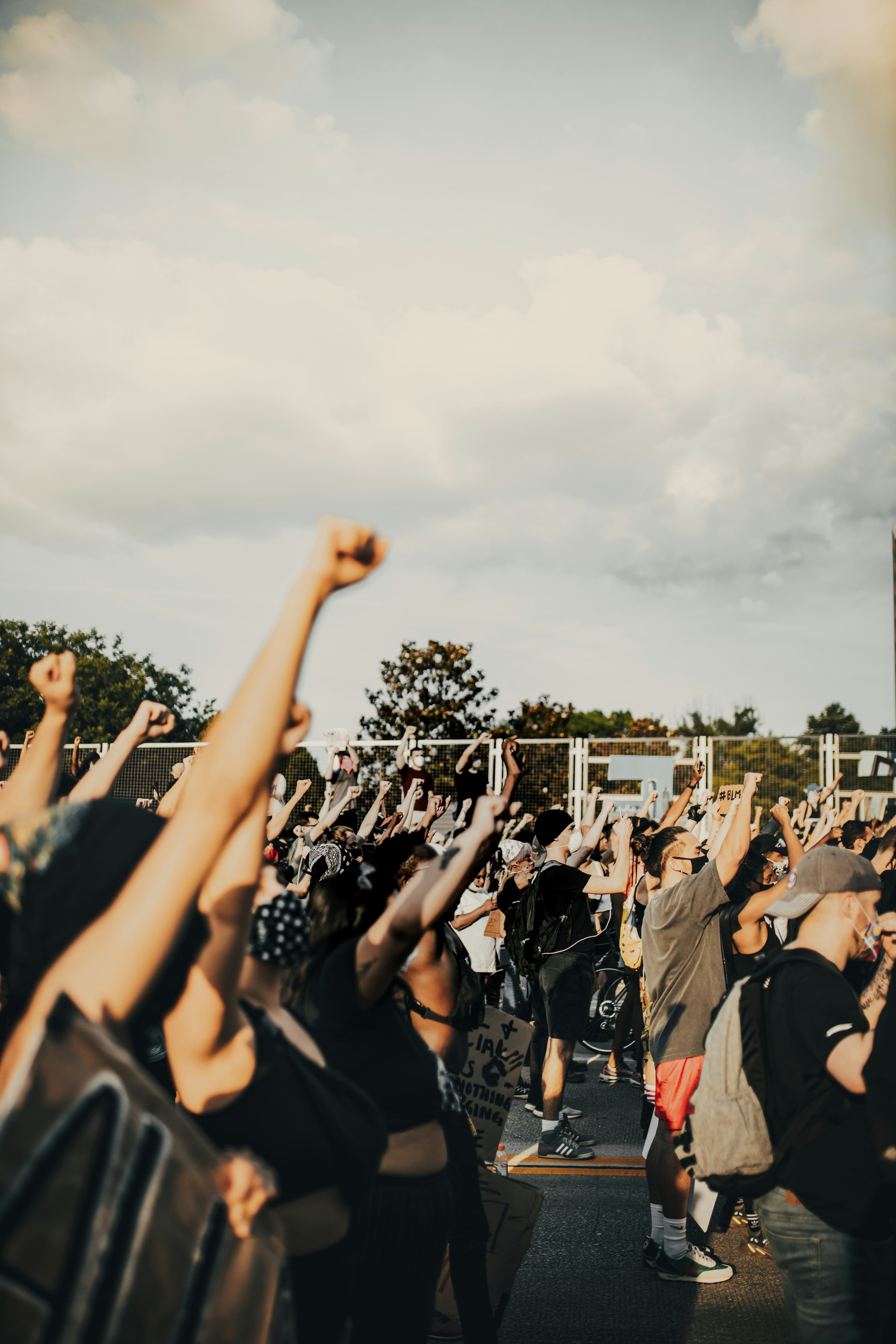 Community members raising fists in solidarity