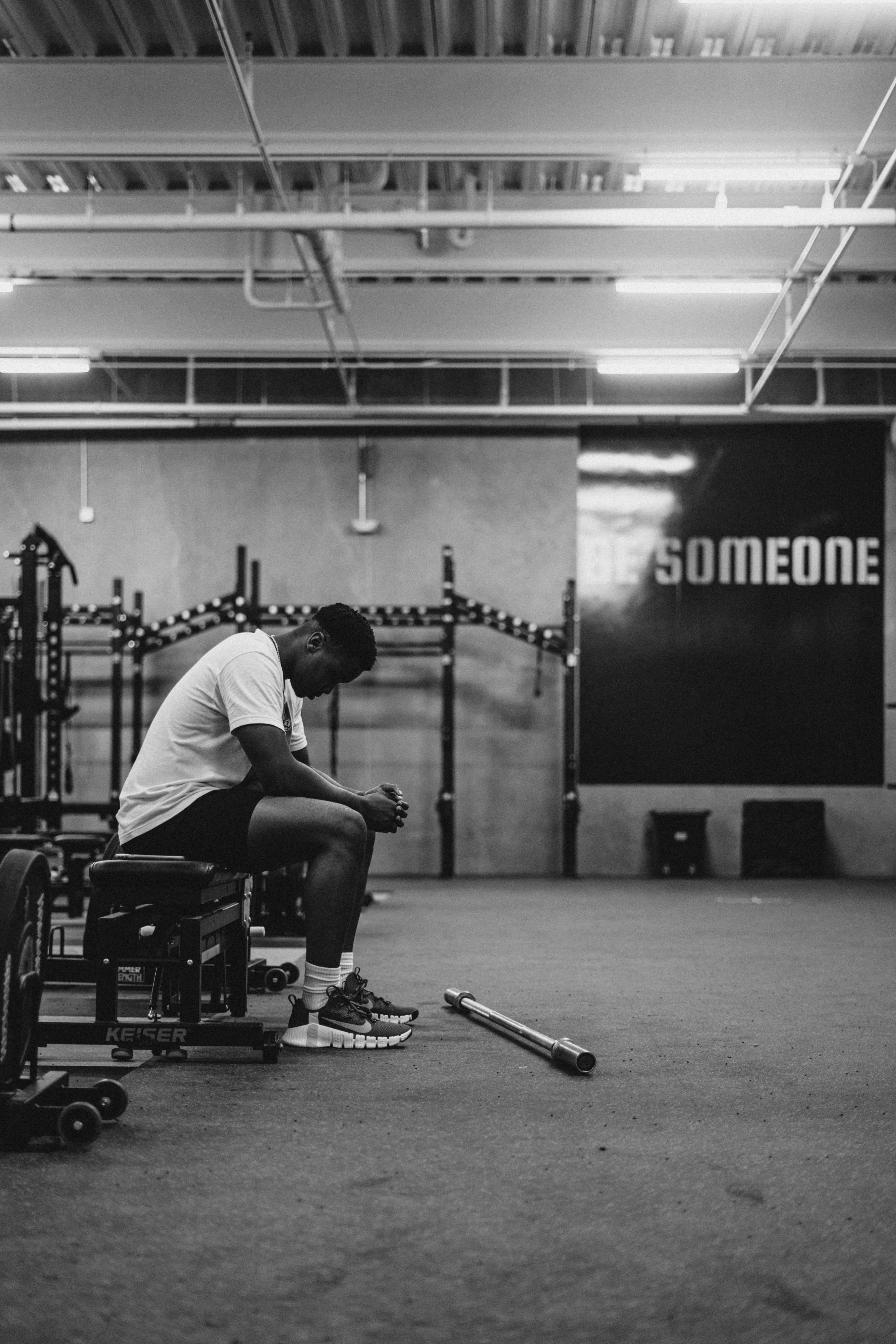 Athlete resting on a bench in a gym